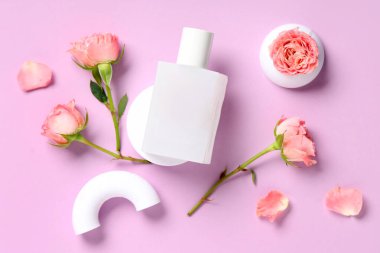 Dekoratif podyumlar parfüm şişesi ve leylak arka planda güzel pembe güller.