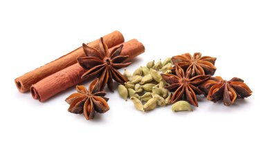 Tarçın çubuklu yıldız anason ve beyaz arka planda kakule tohumu