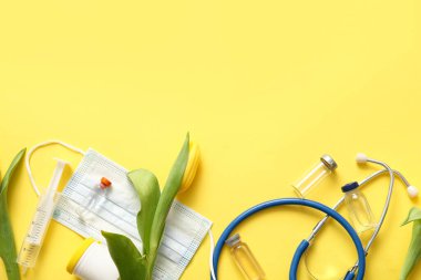 Sarı zemin üzerinde Uluslararası Hemşireler Günü için ampule, maskeye ve lalelere sahip steteskop
