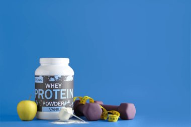 Bottle with protein powder, dumbbells, measuring tape and apple on color background