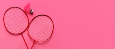 Badminton raketleri ve Pembe arkaplandaki mekikle metin için boşluk, üst görünüm