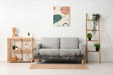 Grey sofa with mold in interior of living room clipart