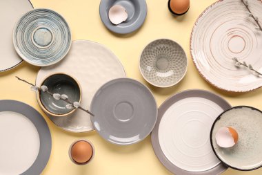 Paskalya yumurtaları ve açık sarı arka planda söğüt dalları olan masa ayarı