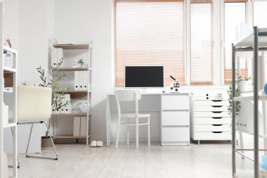 Çalışma yeri ve raf ünitesi olan bir tıp bürosu.