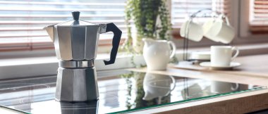Geyser coffee maker on electric stove in kitchen
