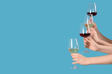 Mavi arka planda şarap kadehleri olan kadınlar. Sevgililer Günü kutlaması