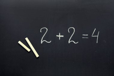 Tahtaya çizilmiş matematiksel ifadeli sarı tebeşirler