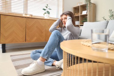 Evde panik atak geçiren genç bir kadın var.