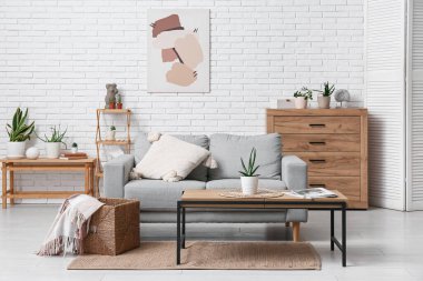 Oturma odasının içi kanepe, masa ve sulu.