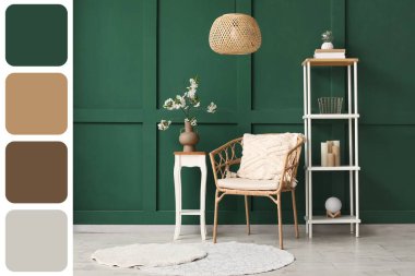 Masanın üzerinde çiçek açan ağaç dalları, rahat koltuğu ve yeşil duvarın yanındaki rafı olan vazo. Farklı renk desenleri