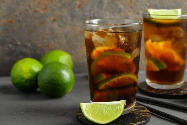 Gri masada soğuk Küba kokteyli ve limon.