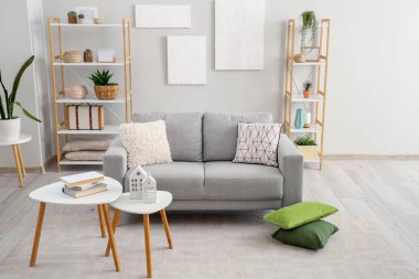 Grey sofa with cushions in interior of modern living room