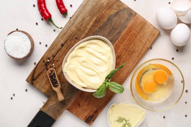 Taze mayonez kaseleri ve beyaz arka planda malzemeler.