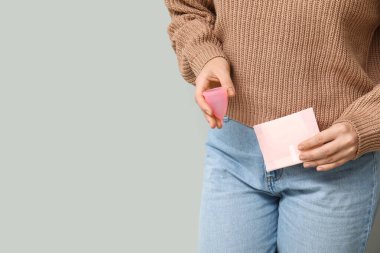 Aybaşı pedi ve fincanı hafif arka planda olan genç kadın, yakın plan.