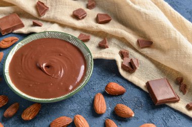 Mavi arka planda lezzetli eritilmiş çikolatalı kompozisyon