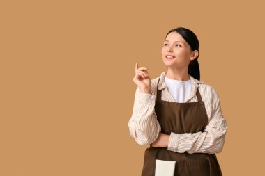 Kahverengi arka planda güzel genç garson