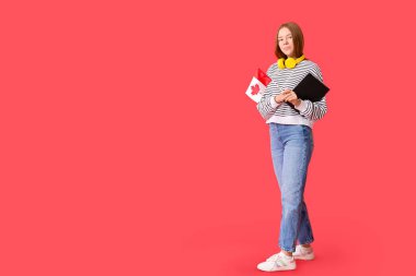 Kırmızı arka planda Kanada bayrağı ve defteri olan kız öğrenci.