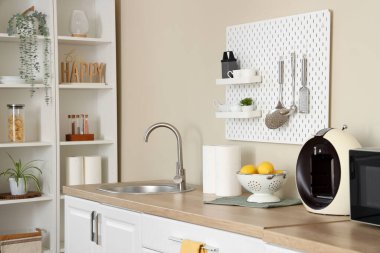 Beyaz tezgahları ve tahta tahtaları olan şık bir mutfak. Yakın çekim.