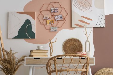 Duvarında kitap ve ruh hali tahtası asılı şık bir sanatçının çalışma alanı