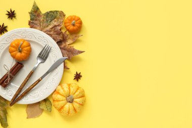 Taze balkabakları, yıldız anason, tarçın ve sarı arka planda sonbahar yapraklarıyla güzel bir masa.