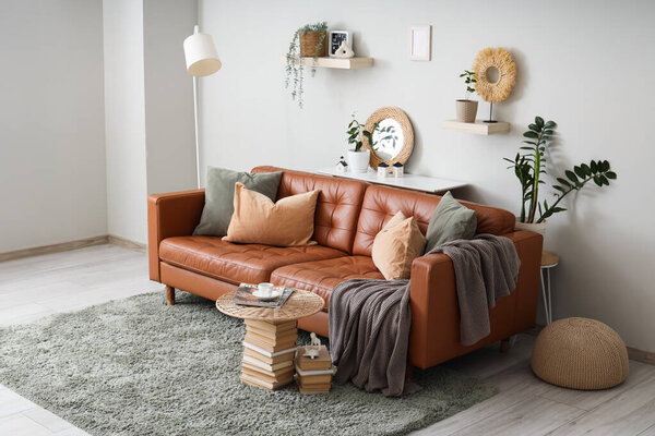Cozy sofa and coffee table made with books in interior of living room