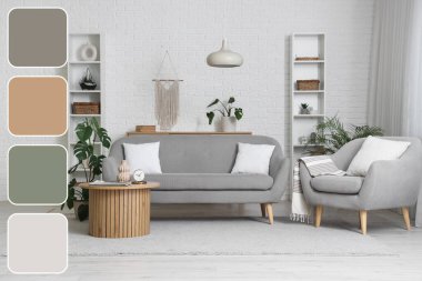 Gri kanepesi, koltuğu ve çiçekli ahşap masası olan aydınlık oturma odasının içi. Farklı renk desenleri