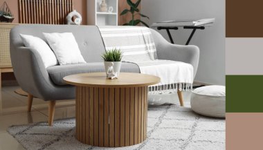 Gri kanepesi ve ahşap masası olan modern oturma odasının içinde. Farklı renk desenleri