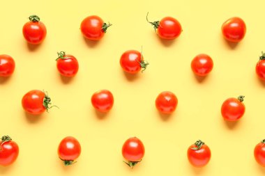 Sarı arka planda bir sürü taze vişneli domates.