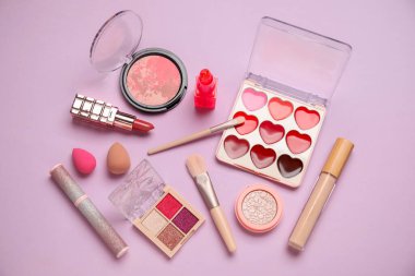 Eflatun arka planda kozmetik ürünler. Üst görünüm