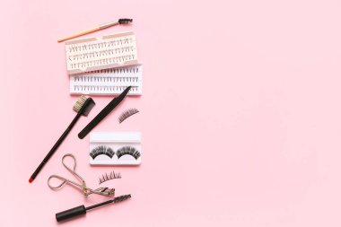 Pembe arka planda araçları olan farklı takma kirpiklerin kümeleri
