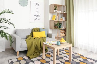 Kanepesi ve raf ünitesi olan şık bir oturma odası.