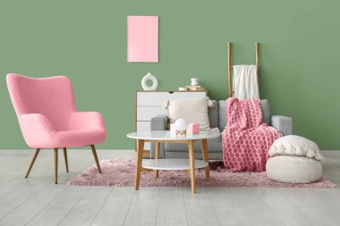 Oturma odasındaki rahat kanepe, koltuk, puf ve kahve masası.