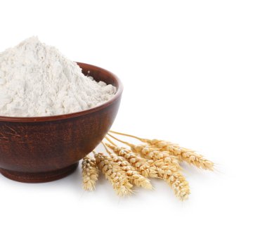 Beyaz arka planda buğday unu ve dikenli tahta kase.