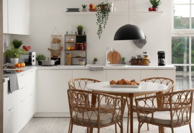 Ahşap yemek masası olan modern mutfağın içi.