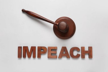 Judge gavel and word IMPEACH on white background