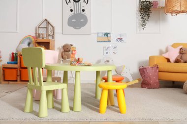 Anaokulunda oyuncak masası ve sandalyeli oyun odası.