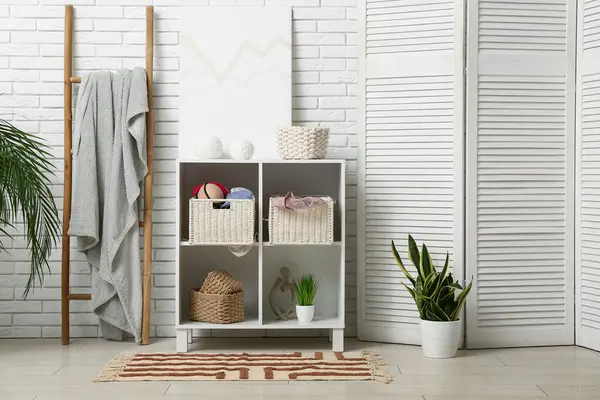 Çekmeceleri, merdiveni ve katlanmış ekranı olan odanın içi.