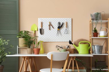 Çalışma yeri, bahçe aletleri ve atölyenin iç kısımlarında bitkiler bulunan tahta.