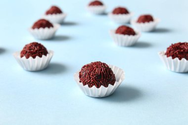 Lezzetli çikolatalı trüf mantarları mavi arka planda kağıt bardaklarda