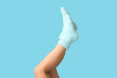 Arka planda sıcak mavi çoraplı genç kadın bacakları