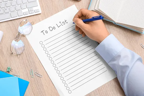 Yapılacaklar listesi, gözlük ve kırtasiye malzemesi olan bir erkek.