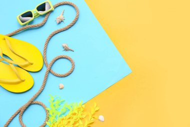 Parmak arası terlikli güneş gözlükleri, deniz kabukları ve renkli arka planda mercan. Yaz konsepti