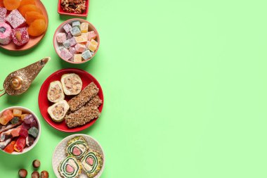Farklı doğu yemekleri ve yeşil arka planda Aladdin lambası olan kompozisyon. Ramazan kutlaması