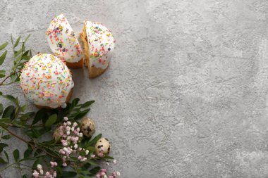 Bıldırcın yumurtalı tatlı Paskalya pastaları ve gri arka planda çingene çiçekleri.