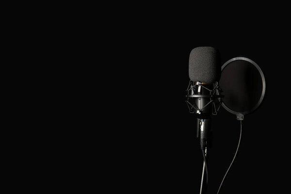 Stand with professional microphone on black background