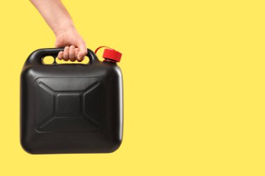 Sarı arka planda erkek el kutusunu tutuyor.