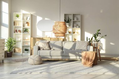 Gri kanepeli, raf üniteli ve aynalı aydınlık oturma odasının içi.