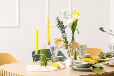 Aydınlık odada bahar çiçekleri olan masa ayarı