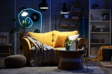 Kanepesi, sehpası ve gece lambaları olan modern oturma odasının içinde.