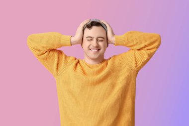 Renkli arka planda yakışıklı, mutlu genç bir adam.